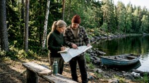 Couple planning cottage by Finnish lake